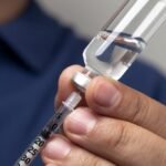 Nurse preparing a syringe for an insulin shot