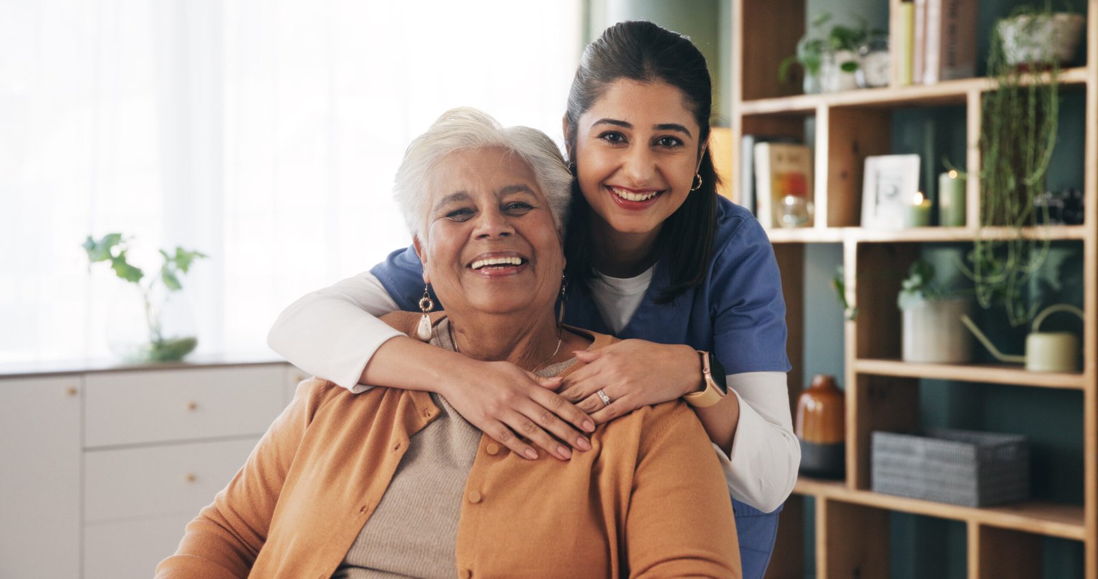 Caregiver hugging elderly patient